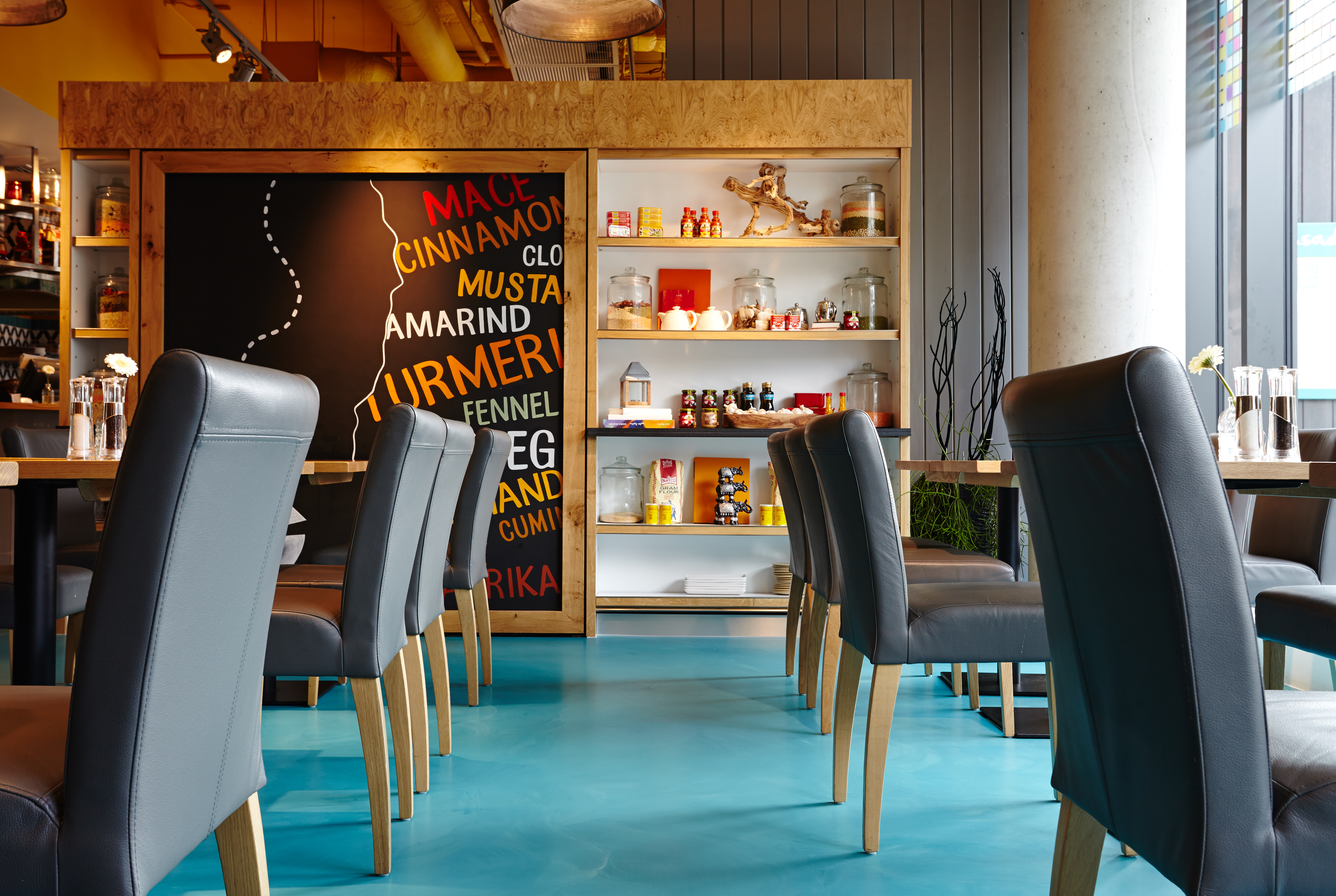 Bright blue resin restaurant flooring with blue chairs