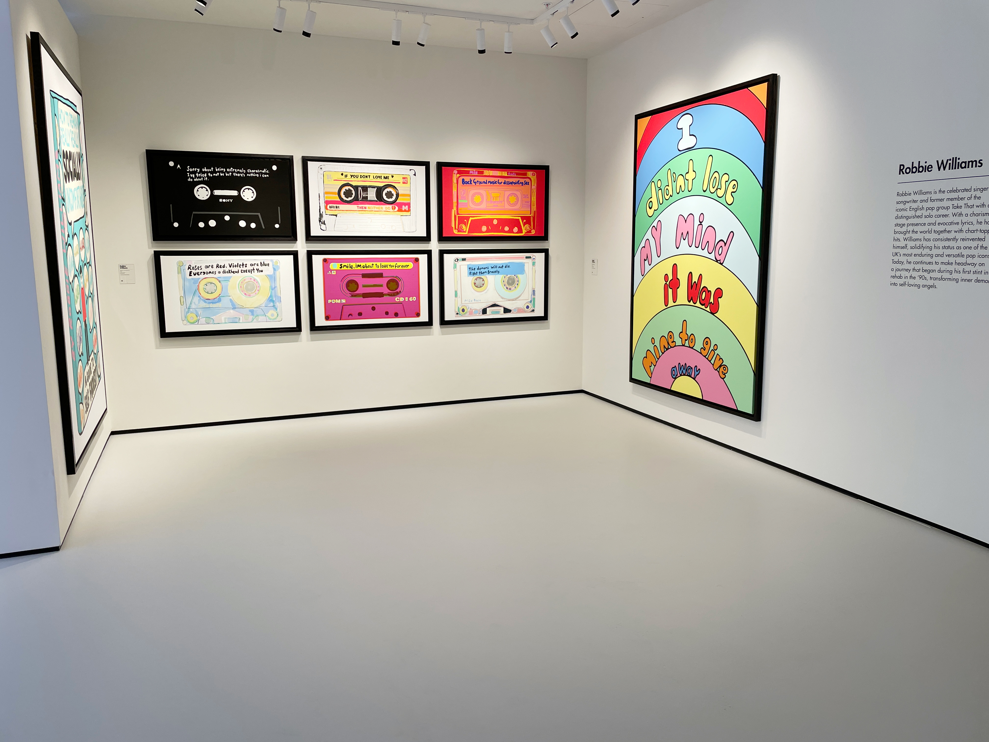 Light grey museum flooring with cassette artwork on the walls