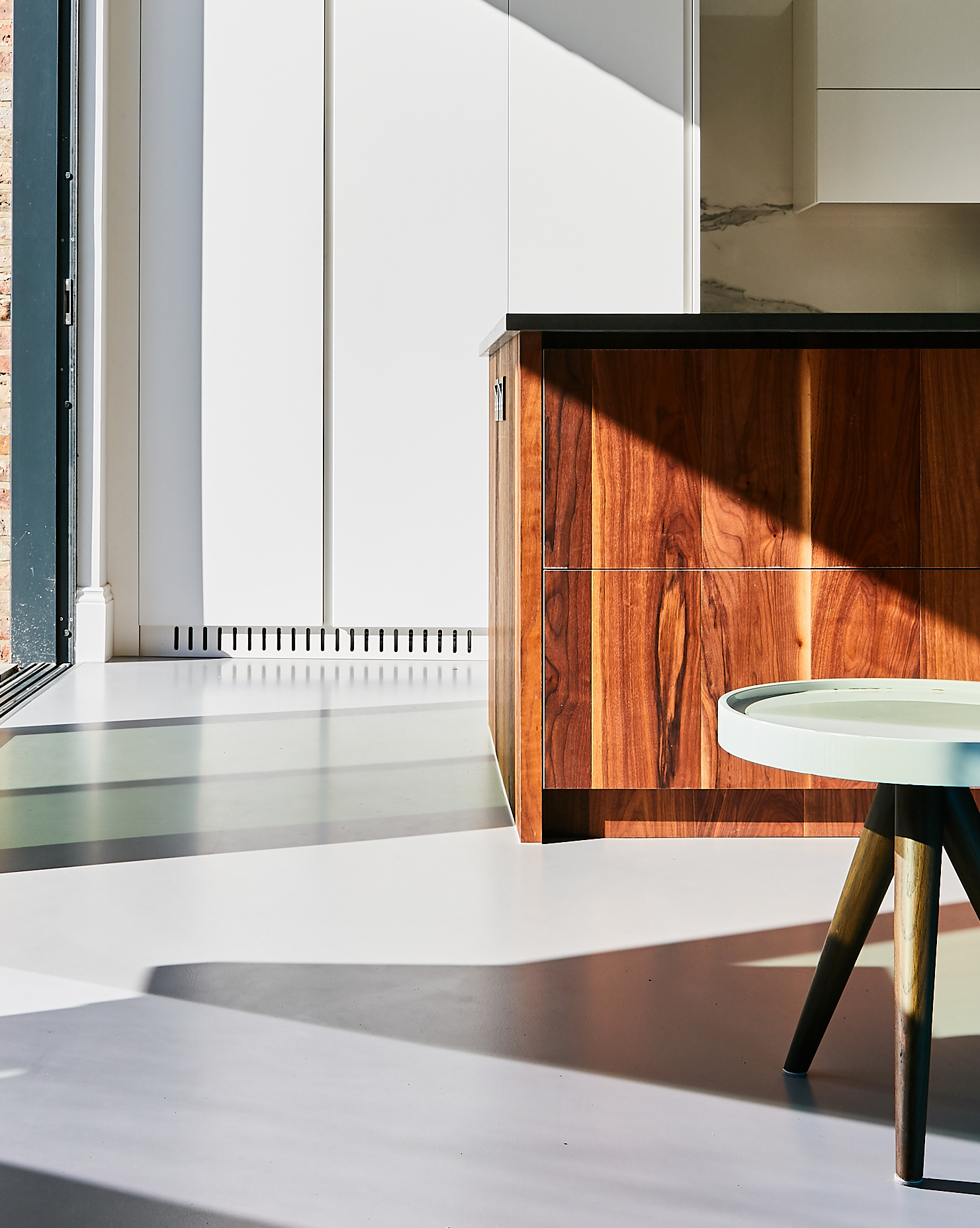 Light grey resin residential flooring in kitchen