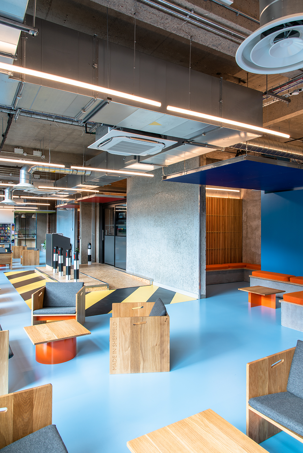 Blue resin floor for student accommodation, with light blue walls