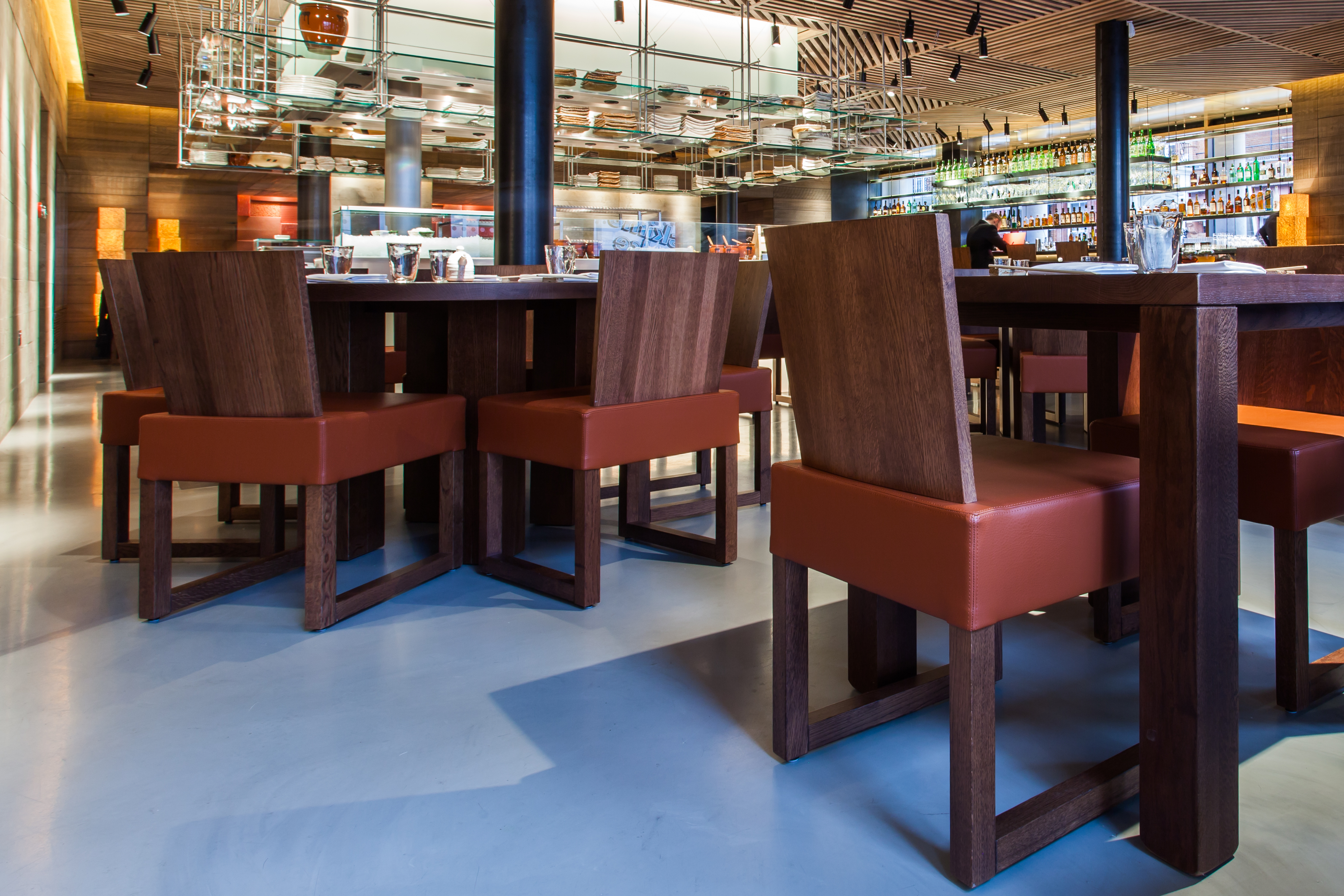 Dark grey resin restaurant flooring with wooden tables and chairs