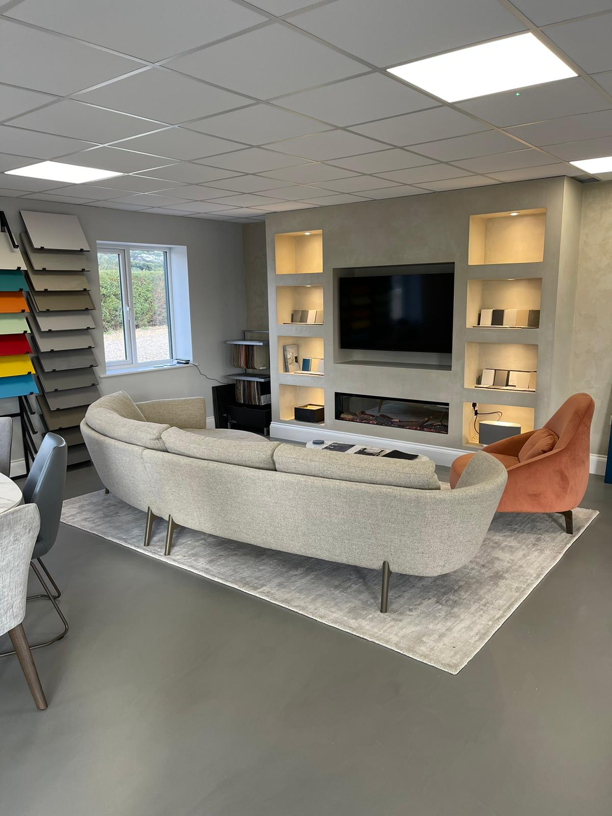 Cambridge showroom with dark grey resin floor, with a grey sofa