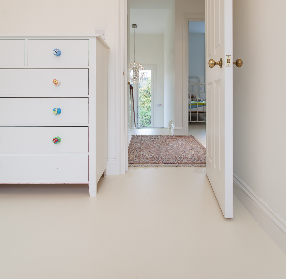 Cream resin residential flooring in bedroom