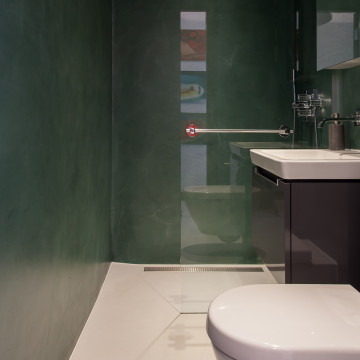 Green walls with white resin bathroom floors