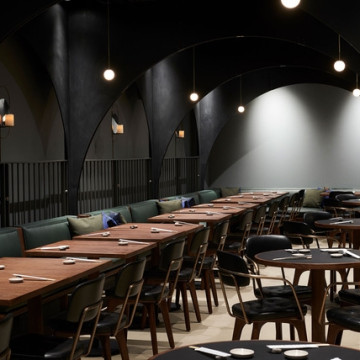 Light grey resin restaurant flooring with long wooden table and chairs