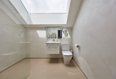 White and warm orange bathroom resin wall finish and floor