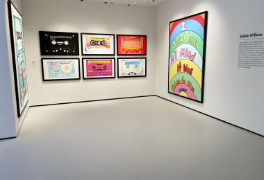 Light grey museum flooring with cassette artwork on the walls