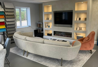 Cambridge showroom with dark grey resin floor, with a grey sofa