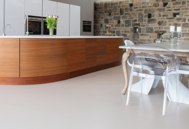 White resin kitchen flooring with light brown wood kitchen island