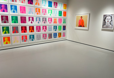 Light grey museum flooring with colourful artwork on the walls