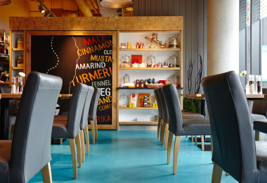 Bright blue resin restaurant flooring with blue chairs