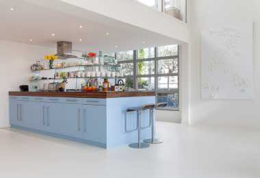 White resin kitchen flooring with blue kitchen island