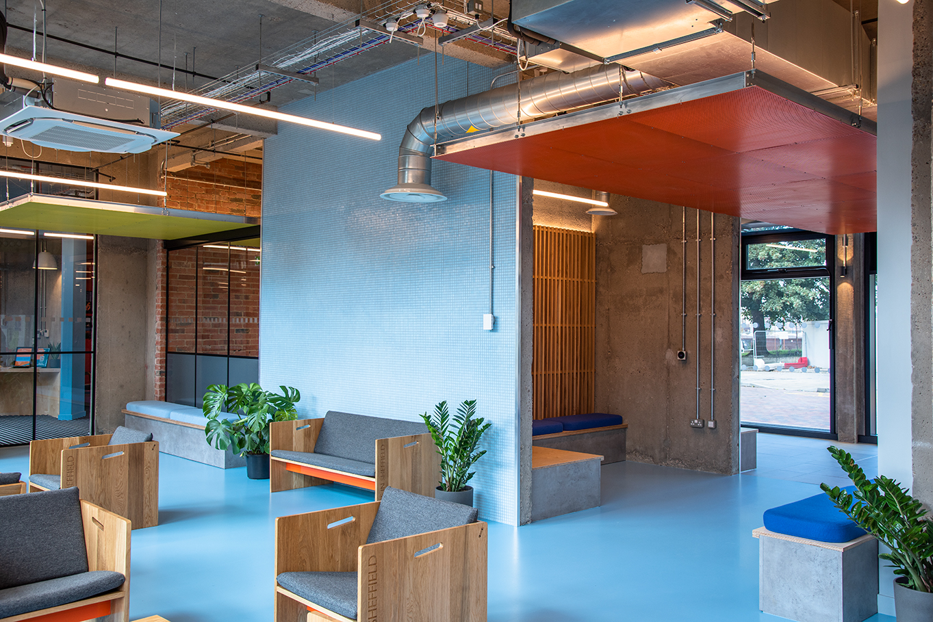 Blue resin floor for student accommodation, with light blue walls and furniture