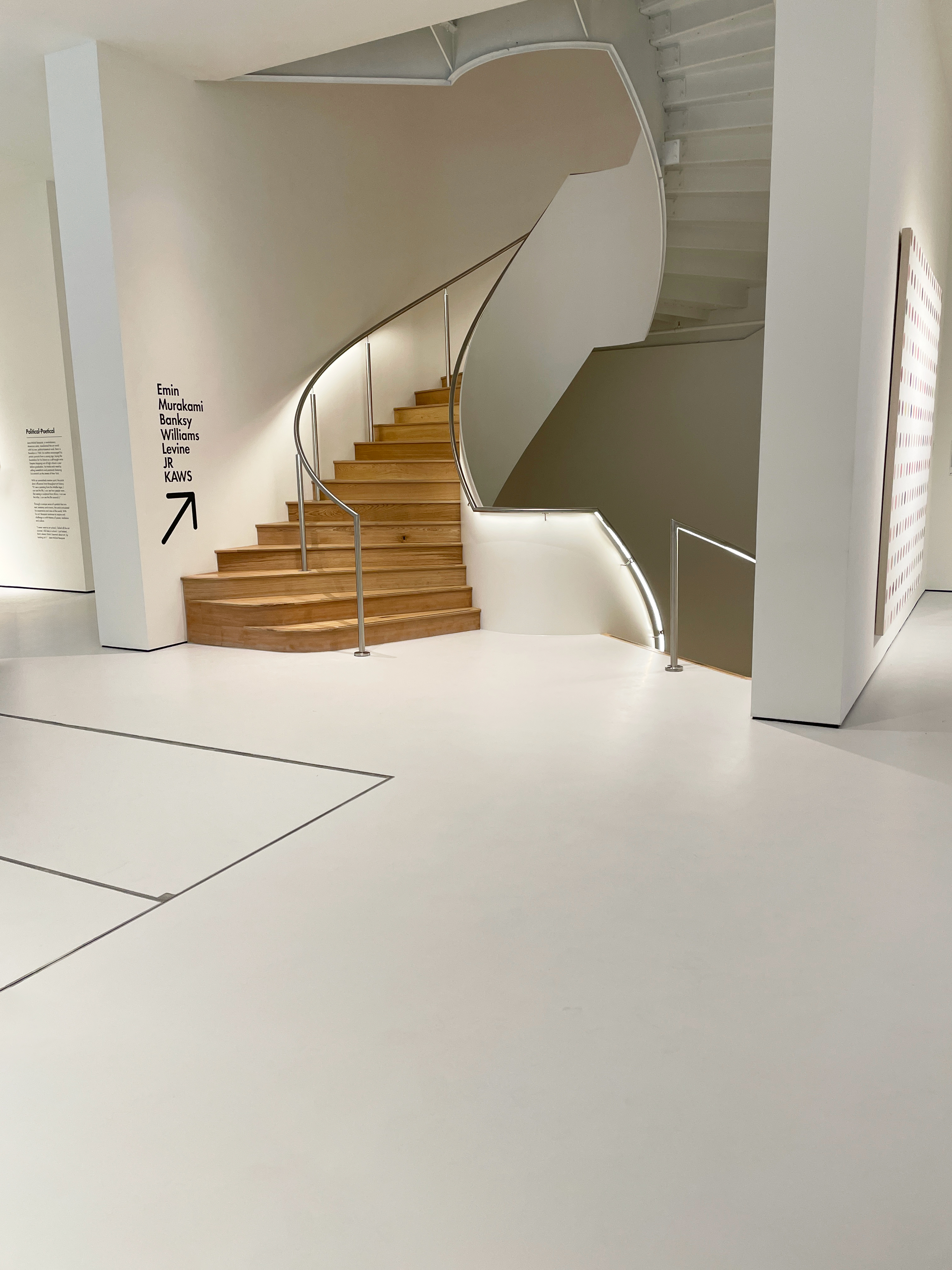 Light grey museum flooring with spiral wooden staircase