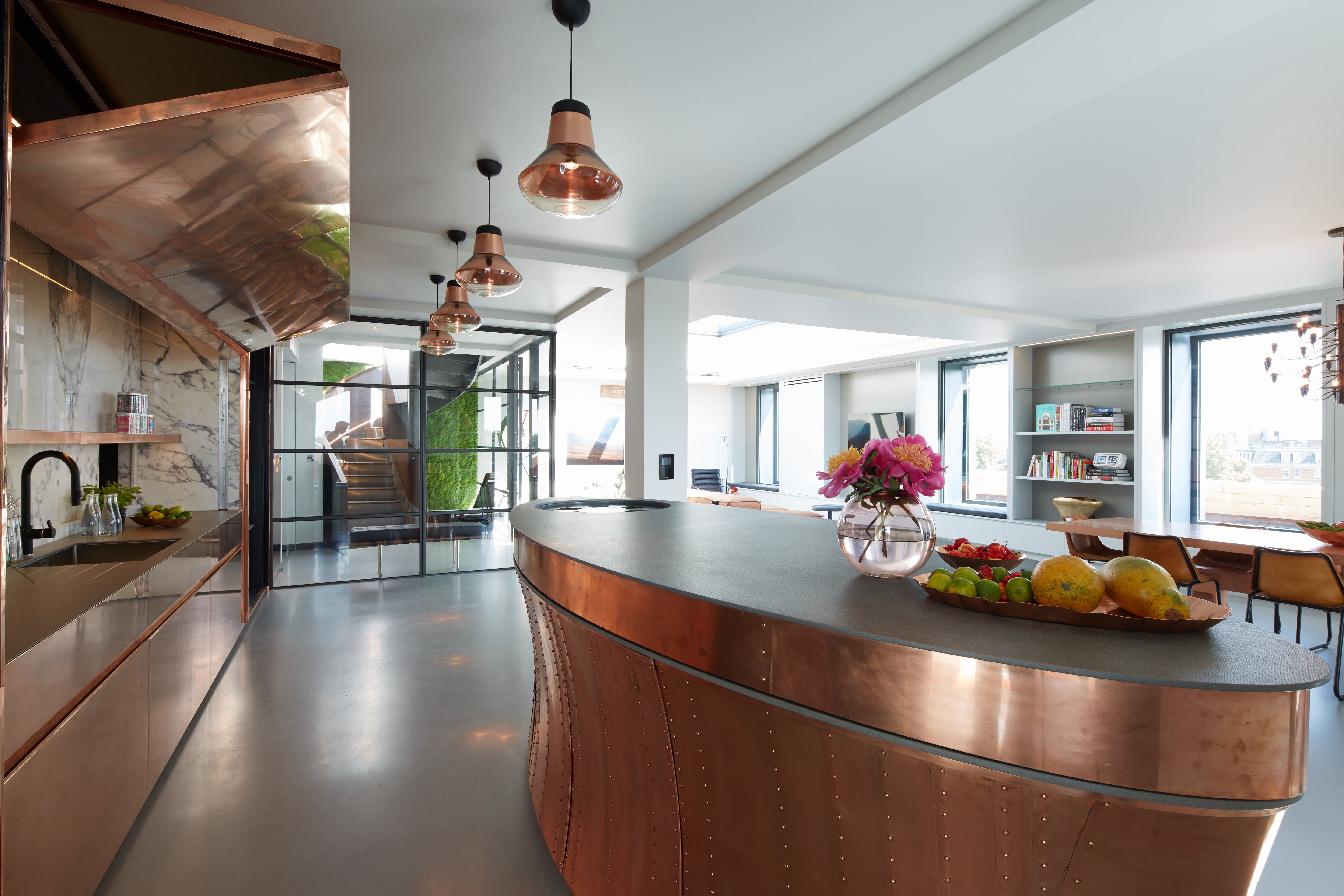 Grey resin kitchen flooring with bronze coloured kitchen island