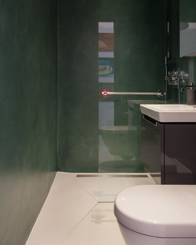 Green walls with white resin bathroom floors