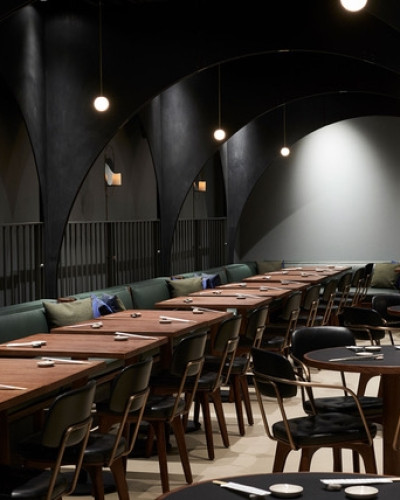 Light grey resin restaurant flooring with long wooden table and chairs