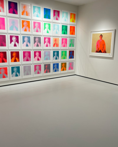 Light grey museum flooring with colourful artwork on the walls